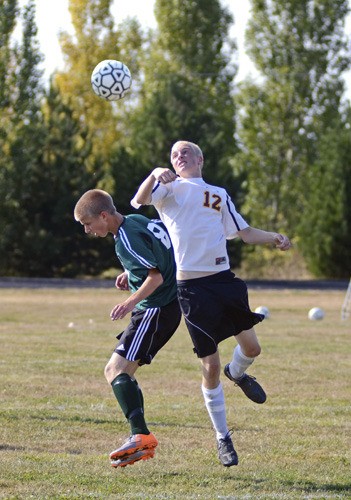 Fletcher Moore (#12) heads the ball against Shoreline Christian in the Lobos' close 3-1 loss at home.
