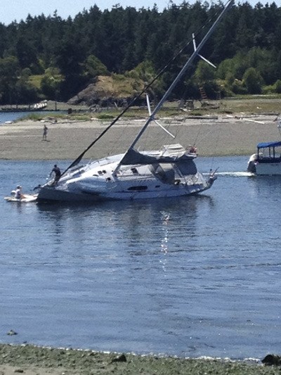 A local sailboat experiences a mishap near Fisherman Bay Spit