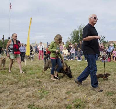 Pet owners parade on the green at the Lopez Center.