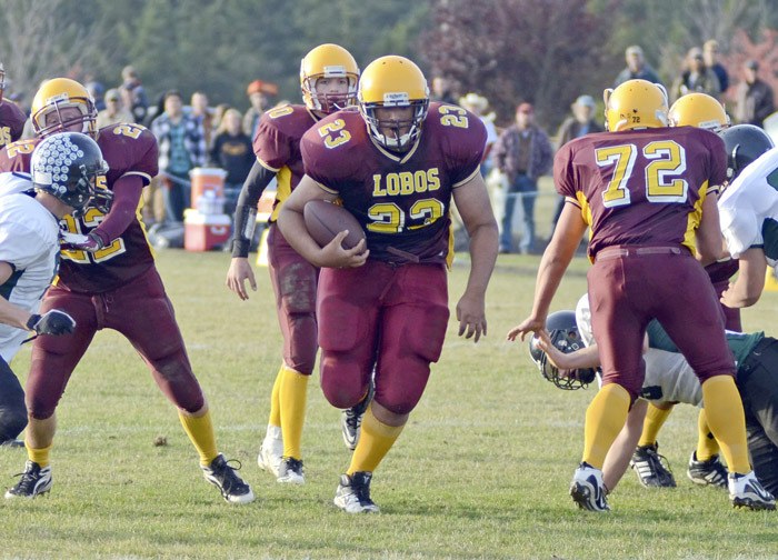 Daniel Jenison (23) takes advantage of a huge hole created by his offensive line in the Lobos 62-38 victory over Evergreen Lutheran.