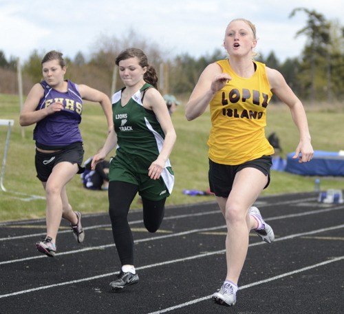 Brianne Swanson takes the lead in the 100 meter dash at the Lopez home track meet April 18.