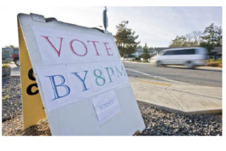 A sandwich board reminding people to vote