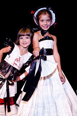 Gwendalynn and Gloryanna wearing dressed fashioned from old floor plans.