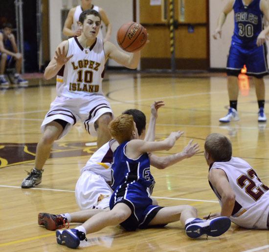 Keldon Jardine (#23) and Chase Schober (on floor in back) gather in a loose ball and pass it to Matthew Haber (#10) against Grace Academy.