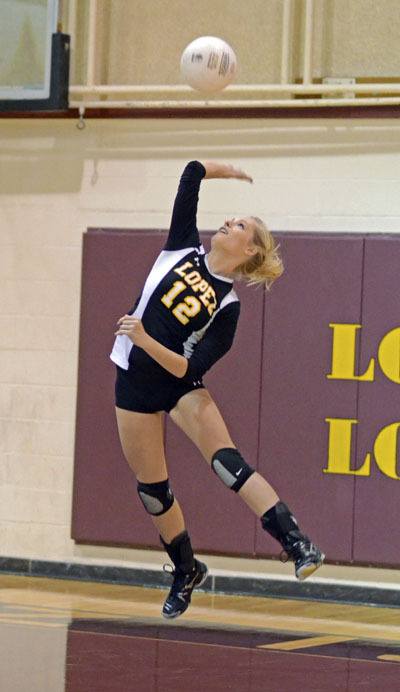 Captain Sarah Stanley delivers her trademark serve in the Lobos victory over Grace Academy.