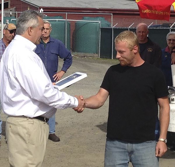 General Manager Foster Hildreth commends Mitchell Barr for his lifesaving action.