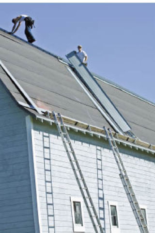 Workers on the roof of the Higgins barn. The roof was replaced with help from a Heritage Barn Grant.