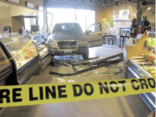 The Volvo SVU crashed through the glass of the Lopez Village Market and came to a stop after it hit the checkout counter by the deli.