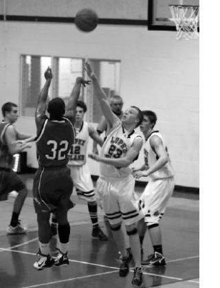 Left photo: Keldon Jardine (23) defends against a Marysville Getchell player in the Lobos’ 53-47 win against the Chargers on Dec. 14.