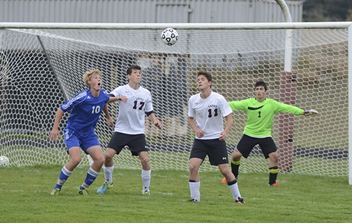 Lopez players Louis Adriaens (17) and Fabio Setti (11) defend against a Grace Academy shot-on-goal while goalie Gavin Goodrich (1) readies for a deflection.