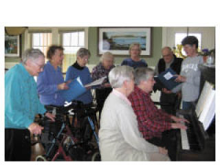 Maureen Rogers accompanies a group of Hamlet House residents during their Oldies’ song fest.