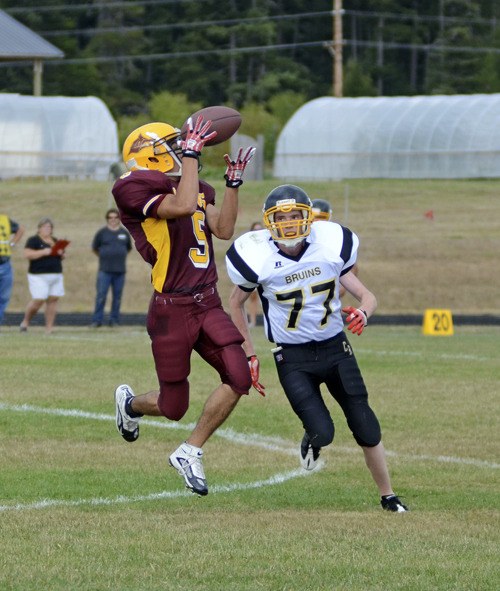 Tak Peralta gathers in a touchdown pass from Keldon Jardine in the Lobos’ 56-12 win over Clallam Bay.