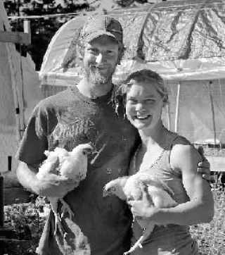 Blake Johnston and Julie Bottjen hold two of their Cornish Cross meat chickens.