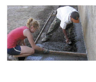 Left: Lopez graduate Laura Strom assists Pedro to build a cement walkway at the cotton spinning cooperative. Work is the operative word when visiting the CDCA.