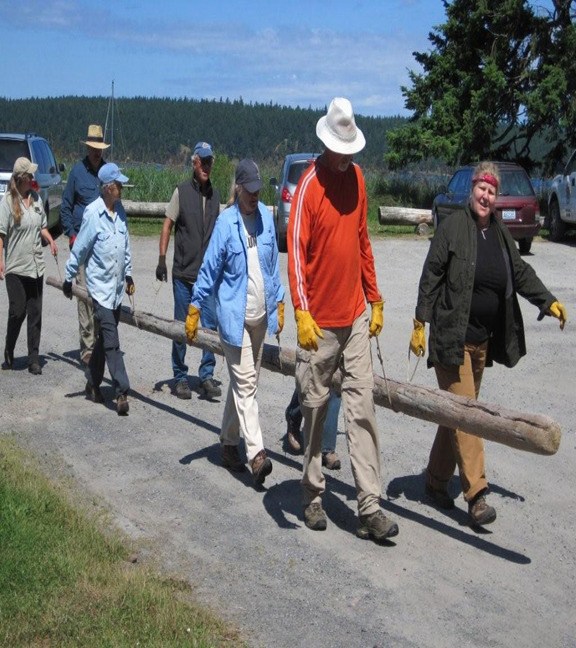 AHS working on carrying a log to the trail.