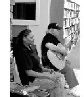 Photos of blues duo James “Curley” Cooke and wife Annette Taborn performing and lecturing on the history of blues