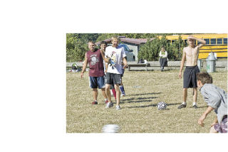 The Lobos soccer team practices shooting goals outside the Lopez school. In the absence of a football team