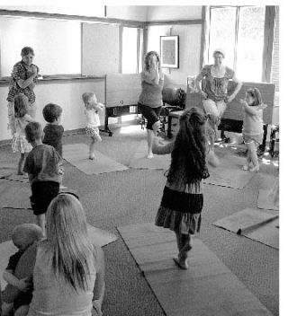 Llewellyne Arden (center) leads some children in the yoga for kids class at the Lopez library. The classes are 11-11:45 a.m. every Thursday during the summer.