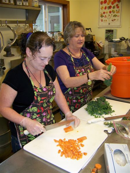 Dana Cotten and Samantha Taylor and preparing food in the Lopez School cafeteria. The Italian Dinner and silent auction
