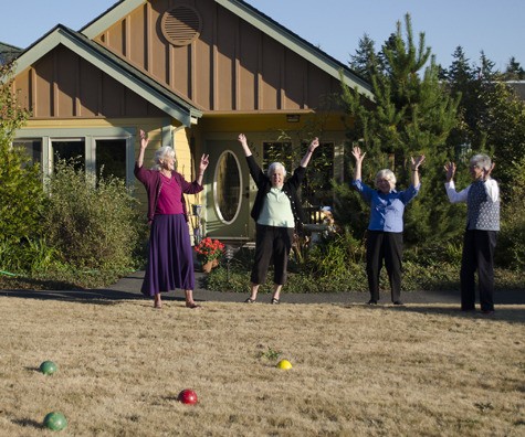 Friends enjoy a bocce ball game at the Hamlet Cottages.