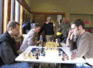 Chess tournament players absorbed in their game.