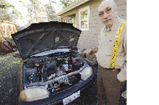 Gary Zerbst stands in front of his 1995 Geo Metro. The car is now fully electric.