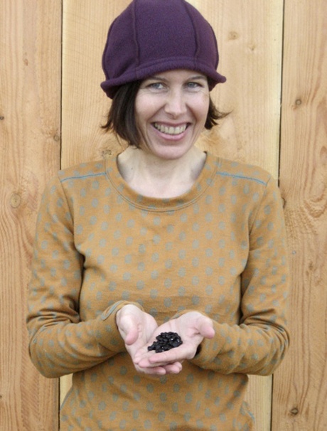 Nancy Rankin holds the black bean seeds shell plant soon on Lopez.