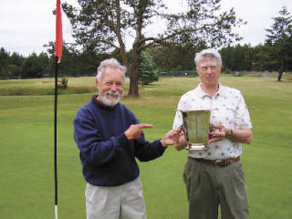 Last year’s winner Bill Gregory (left) handing over the 2008 trophy to Jerry Dupuis