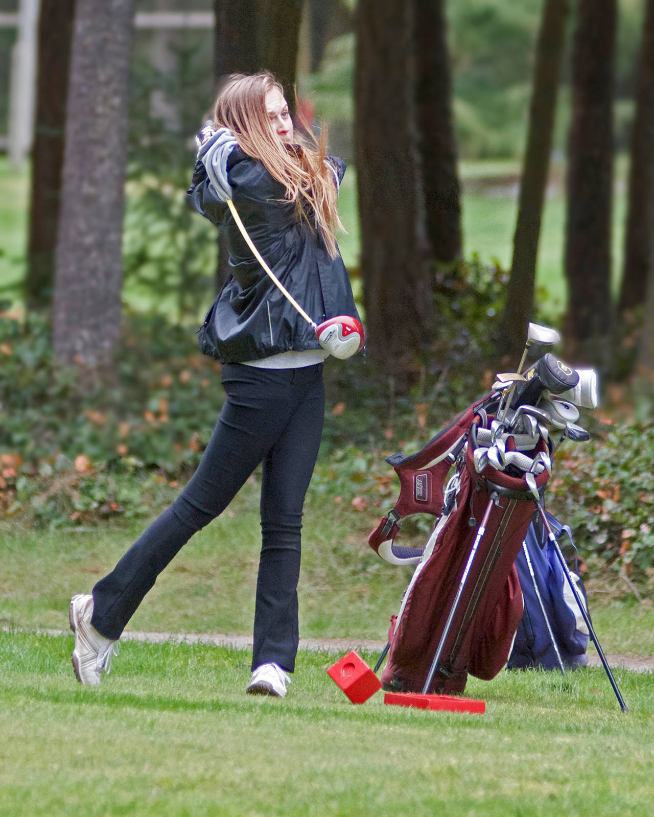 Kate Combs drives off the 6th tee at the Lopez golf course in the April 4 match versus Friday Harbor. Combs won top honors against Grace Academy on March 23. Photo by Gene Helfman.