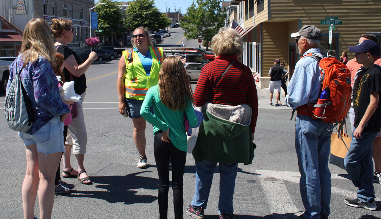 Staff photo/Hayley Day                                A Washington State Ferry employee answers questions about delays at the Friday Harbor terminal on Tuesday, July 18.