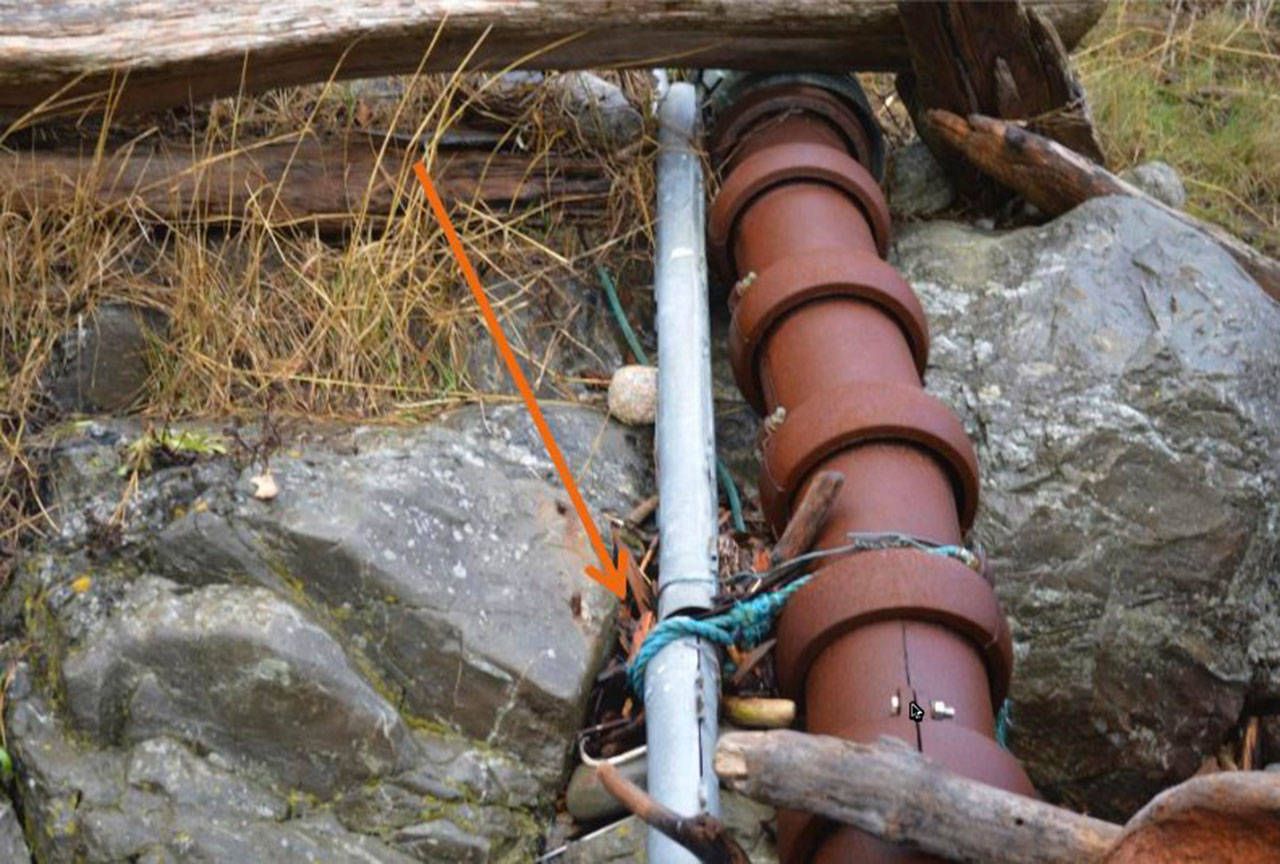 Contributed photo/Public Records Request                                CenturyLink’s fiber cable is connected to OPALCO’s power cable with rope and wire near the Pear Point substation.