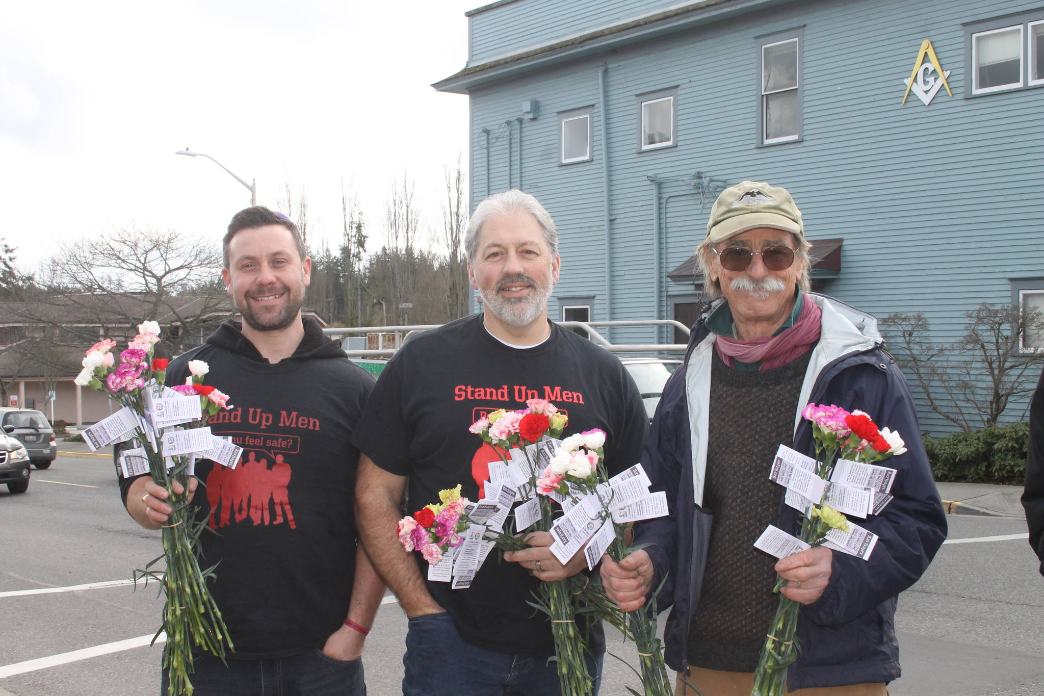 Staff photo/Heather Spaulding                                John Stamey handing out flowers.
