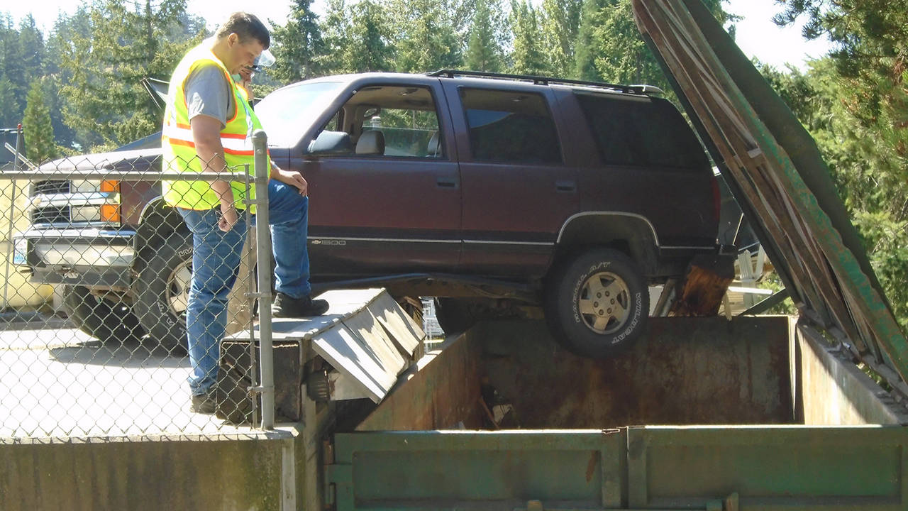 SUV dangles dangerously at the Lopez Dump