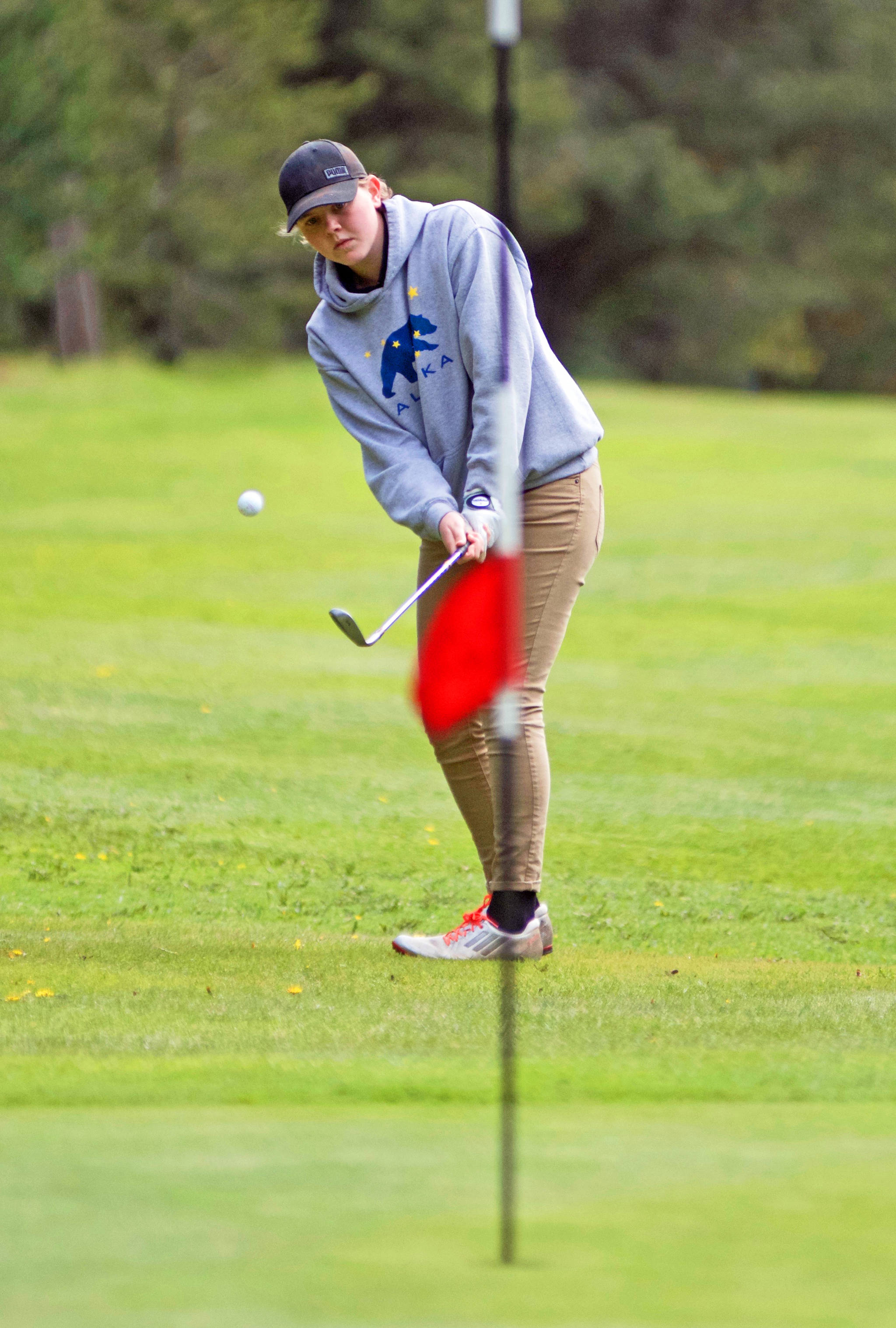 Contributed photo                                Senior golfer Zoe Reinmuth chips onto the fifth green at the Lopez Golf Course in recent match play against Grace Academy.