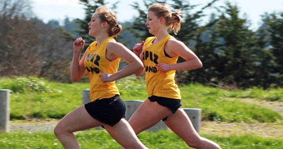 Contributed photo
Clara Ewert (foreground) and Erin Wilbur compete stride-for-stride in the 880-yard run — the toughest race in track — during a Lopez meet in April 2011.