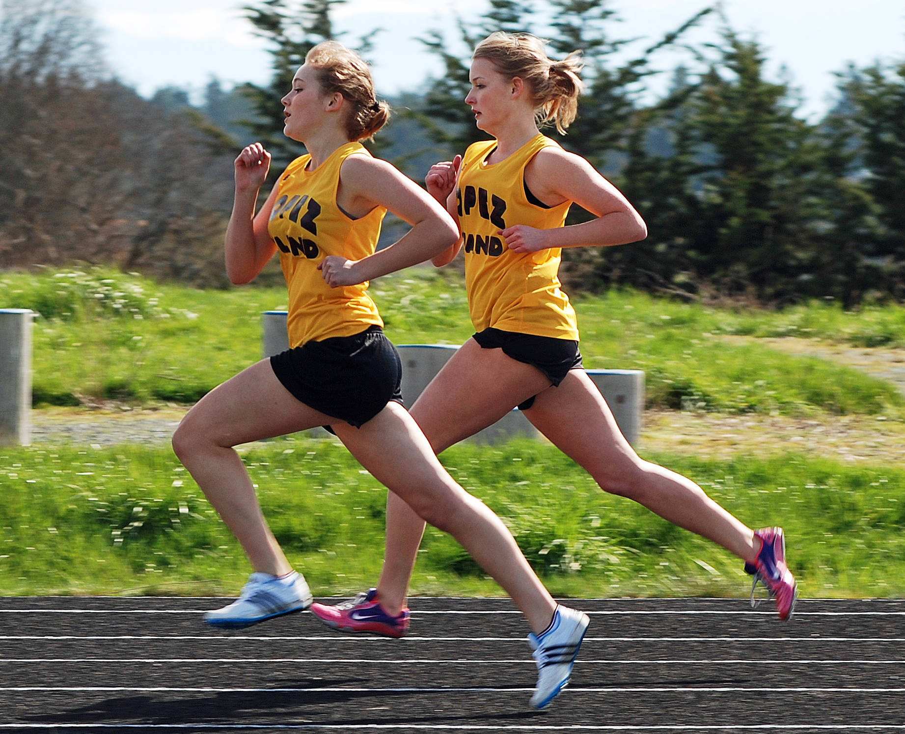 Contributed photo
Clara Ewert (foreground) and Erin Wilbur compete stride-for-stride in the 880-yard run — the toughest race in track — during a Lopez meet in April 2011.