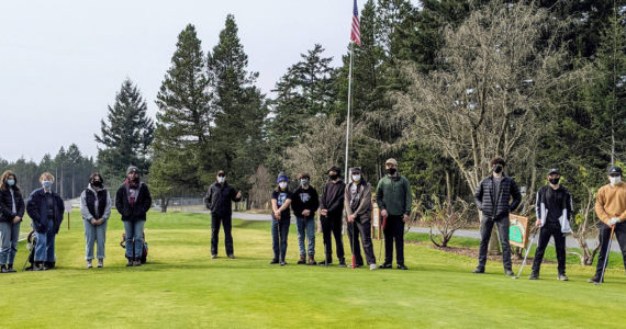 In order of left to right: Phoebe McGown; Lucy McGown; Lily Stovall; Valentina Rendon; Coach Richard Tetu; Jacob Sanford; Kyle Kinney; Brandon Kinney; Zachary Sanford; Simon Rosevear; Levi McClerren; Andrew Auckland; and Ananda Velo. Not pictured are: Morgen Limbach; Freda Kvistad; Kate Auckland; and Hannah Roberson.