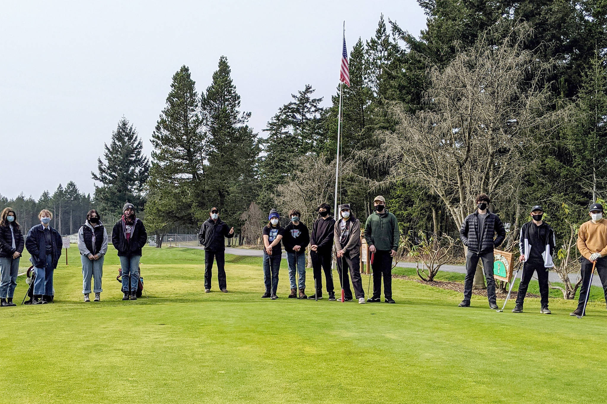 In order of left to right: Phoebe McGown; Lucy McGown; Lily Stovall; Valentina Rendon; Coach Richard Tetu; Jacob Sanford; Kyle Kinney; Brandon Kinney; Zachary Sanford; Simon Rosevear; Levi McClerren; Andrew Auckland; and Ananda Velo. Not pictured are: Morgen Limbach; Freda Kvistad; Kate Auckland; and Hannah Roberson.