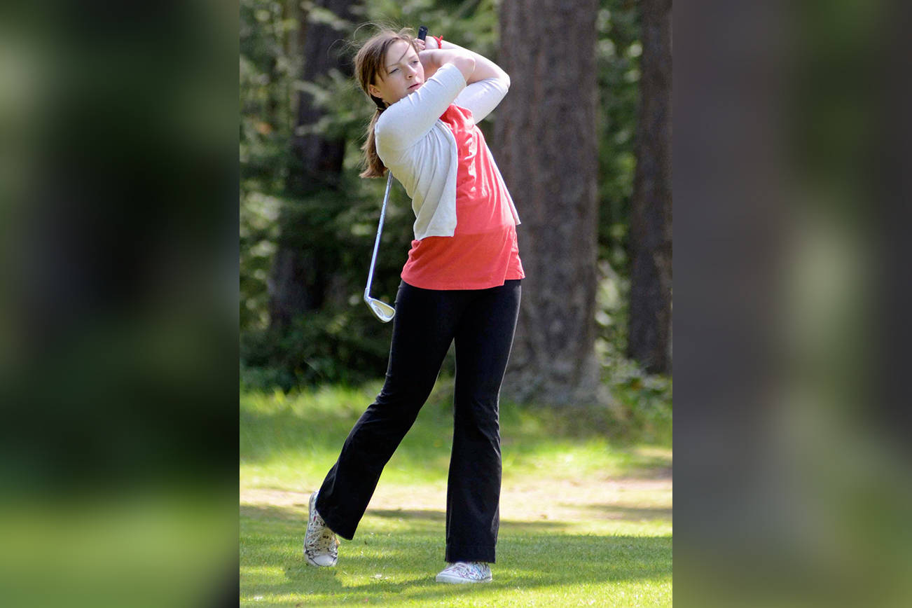 Contributed photo
Sarah Reeve hits a long iron on the ninth hole at Lopez in a match against Friday Harbor in April 2012.