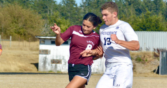 Contributed photo/Lopez midfielder Leah Armstrong fights for the ball against a Providence Christian player in the Lobos’ home opener, Sept. 9.