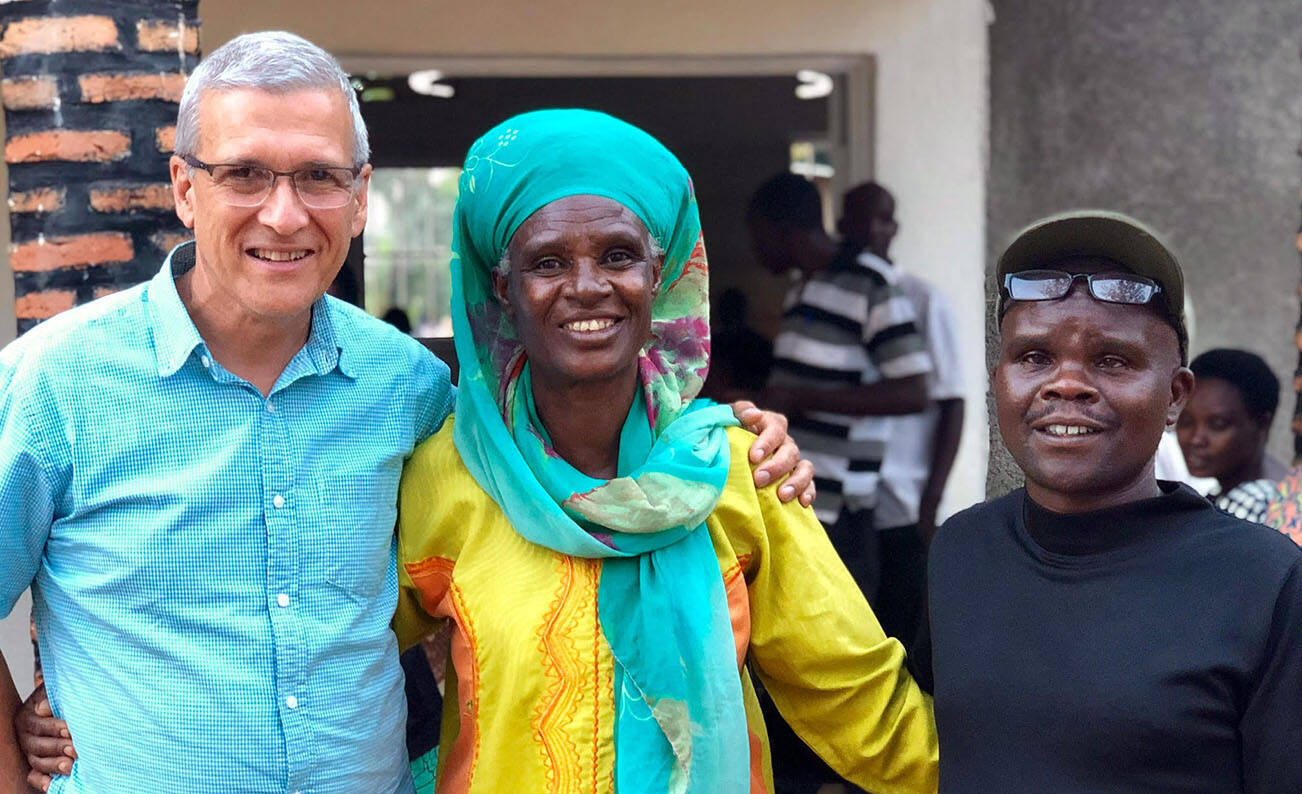 Photo courtesy of Carl Wilkens 
Above: Wilkens in Rwanda in 2019 with a survivor who has reconciled with the man who killed her husband and sons.
Right: Wilkens in Rwanda with his family 1990.
