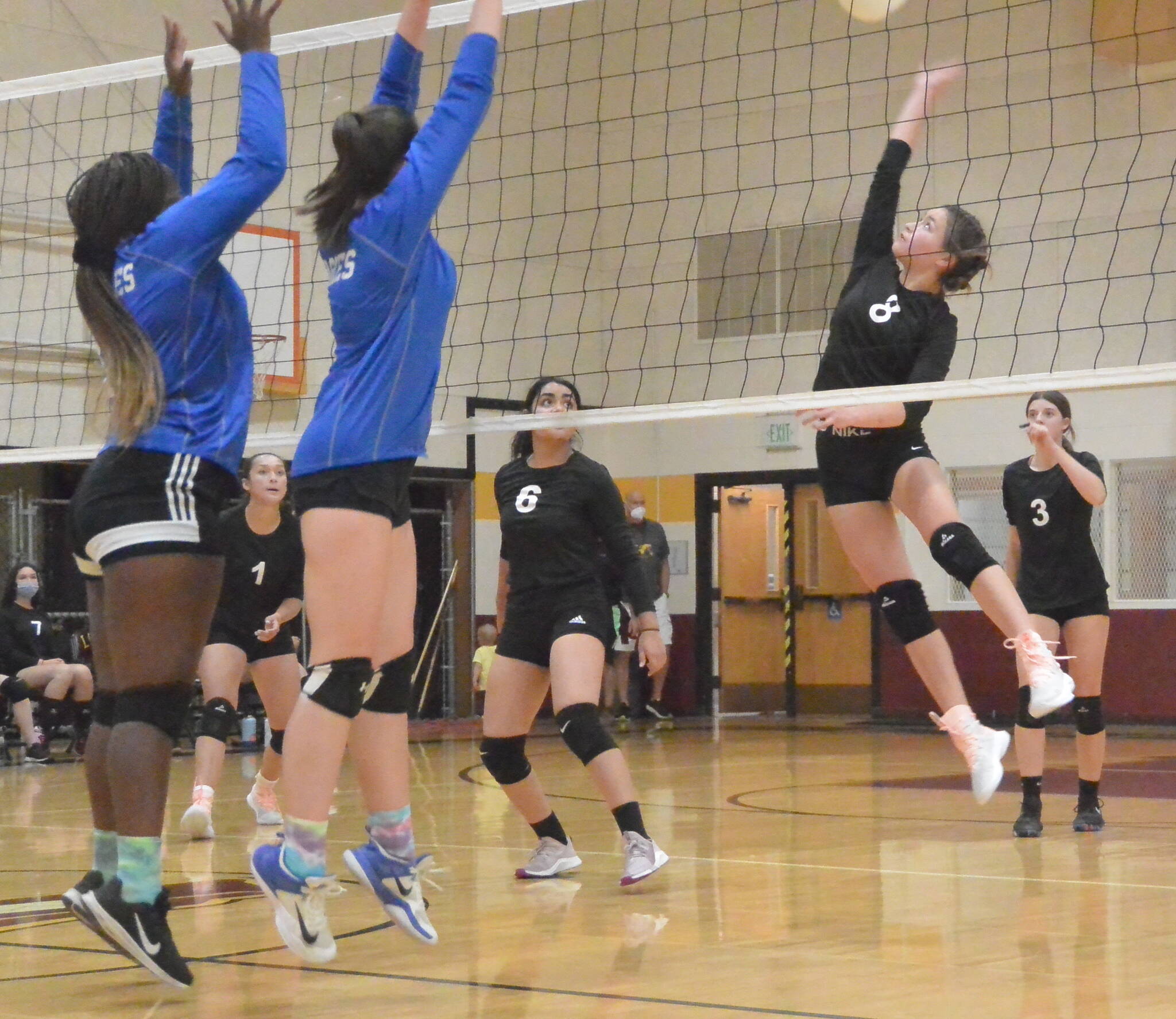 Gene Helfman photo/Jamie Armstrong (#8) spikes the ball as Sophie Allen (1), Valentina Rendon (6), and Camille Steckler (3) look on in the match against Grace Academy, Sept. 13.