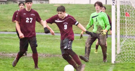 Contributed photo
Ananda Velo (9) clears the ball from in front of the Lopez goal as Josh Kramer (27) and keeper Levi McClerren (1) help defend against Mt. Vernon.