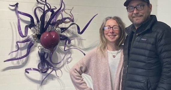 Staff photo/ Sienna Boucher.
Jennifer Anderson (left) and Rahman Anderson (right) posing in front of a glass heart in their gallery.