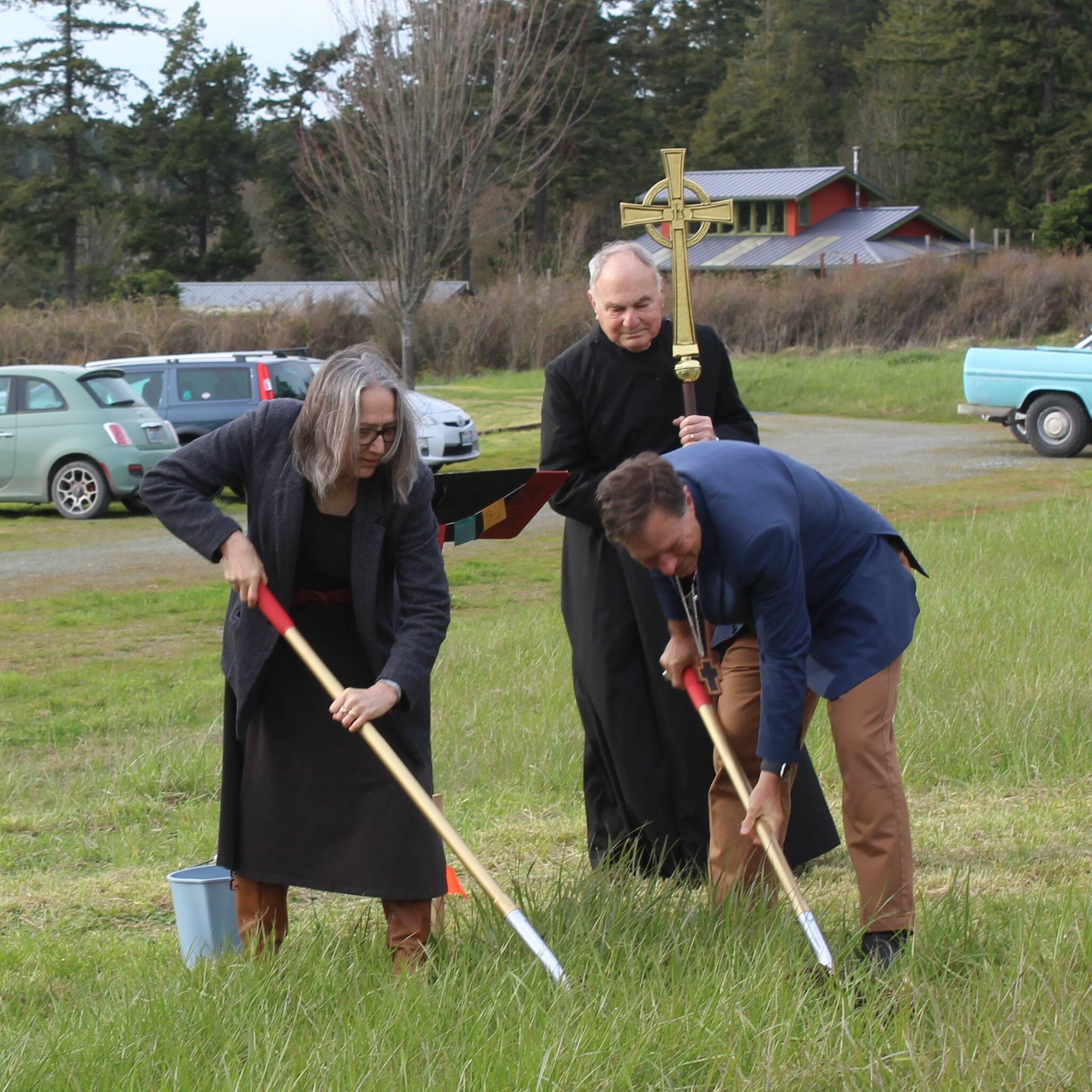 Contributed photo/Bishop Greg Rickel, and Senior Warden Mary Ann Riggs, weilding the shovels, with crucifer Don Langrock (Campaign Fund Treasurer).