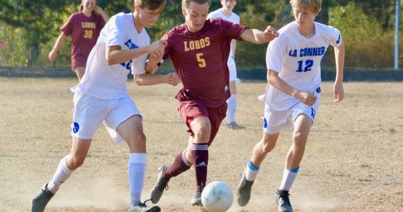 Contributed photo
Malachi Cary (5) fights off two Braves defenders on his way to his second goal in Lopez’ 3-0 win over La Conner Oct. 13th.