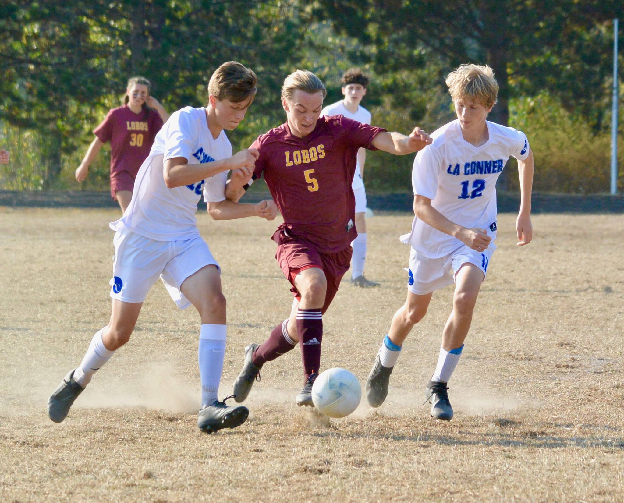 Contributed photo
Malachi Cary (5) fights off two Braves defenders on his way to his second goal in Lopez’ 3-0 win over La Conner Oct. 13th.