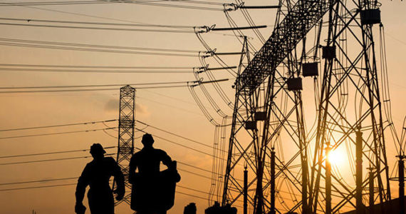 Contributed photo by OPALCO
Silhouette of engineer looking at blueprints in a building site over Blurred substation