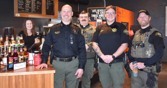 Kelley Balcomb-Bartok Staff photo
Sheriff Eric Peter is flanked by 13 Ravens Coffee owner Liberty Miller (left), and officers Nick Wainwright, Rion Brandt, and Jay Holt during the department’s first “Coffee With A Cop” event held January 28 in Friday Harbor.