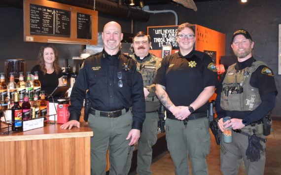 Kelley Balcomb-Bartok Staff photo
Sheriff Eric Peter is flanked by 13 Ravens Coffee owner Liberty Miller (left), and officers Nick Wainwright, Rion Brandt, and Jay Holt during the department’s first “Coffee With A Cop” event held January 28 in Friday Harbor.